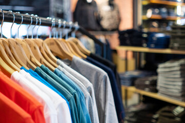 Colorful t-shirt hanging in fashion department store at shopping mall