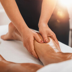Fototapeta na wymiar Anti Cellulite Massage. Masseuse Massaging a Female Calf