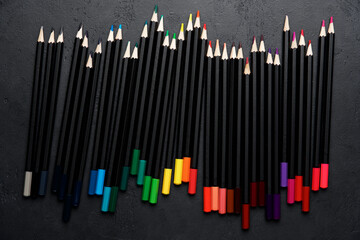 Color pencils on black background. Educational or back to school background