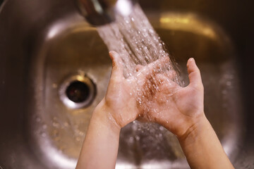 Fototapeta premium Hygiene rules. Hand washing before meals. Antibacterial treatment of hands with soap. A way to prevent virus infection. Coronavirus protection.