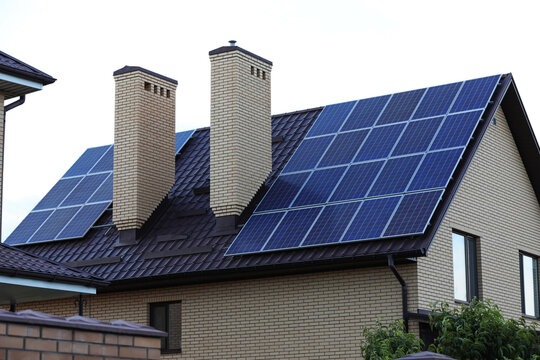 House with installed solar panels on roof