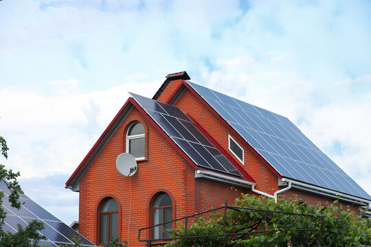 House with installed solar panels on roof