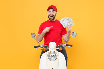 Delivery man in red cap t-shirt uniform driving moped motorbike scooter hold cash money isolated on...