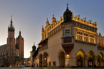 Naklejka na ściany i meble St Mary's Basilica and the Cloth Hall Building in Krakow Poland at dawn.
