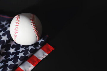 American traditional sports game. Baseball. Concept. Baseball ball and bats on a table with american flag.