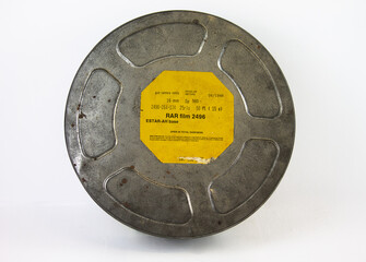An original old film can with an orange label. For 16 mm film rolls.