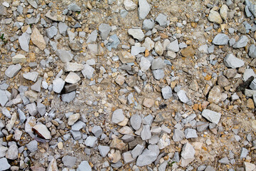 Texture gravel in its natural state with sand as background. As seen on the mountain.