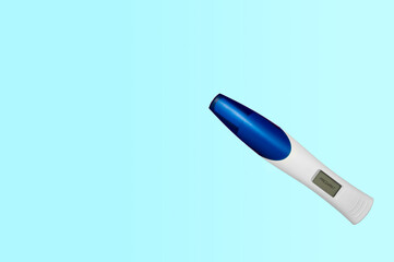 Digital pregnancy test isolated on a blue background indicating that the woman is pregnant