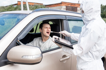 Test driver check for coronavirus, bubonic plague at border of cities and countries, doctor takes smear from man