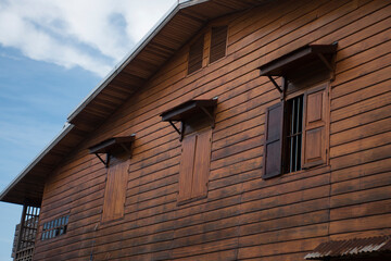 Wooden windows and siding made of brown wood