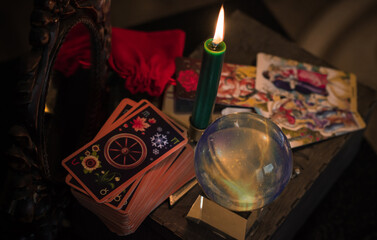 Naklejka na ściany i meble Magic crystal ball fortune teller ,love telling, esoteric concept, mystical scene with candles, tarot cards on a table