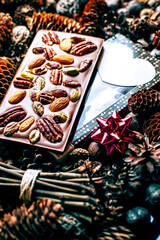 Composition of chocolate with nuts on cones background