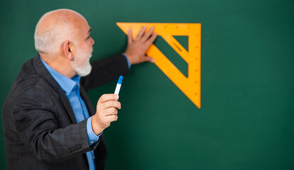 sequential subject. Mathematics at board. favorite subject. senior man teacher use math triangle...