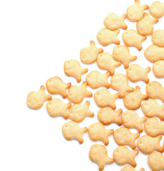 Delicious crispy goldfish crackers on white background, top view