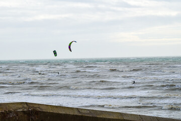 Two kitesurfers on the waves