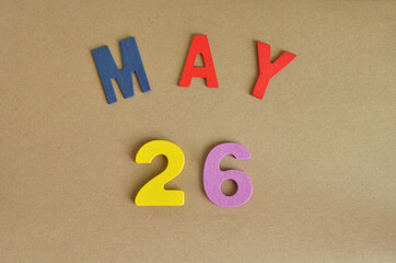 May 26, Toy alphabet with a brown background.