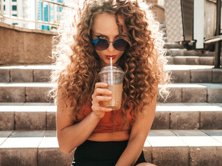 Young beautiful smiling hipster woman with afro curls hairstyle.Girl in summer trendy clothes...