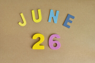 June 26, Toy alphabet with a brown background.