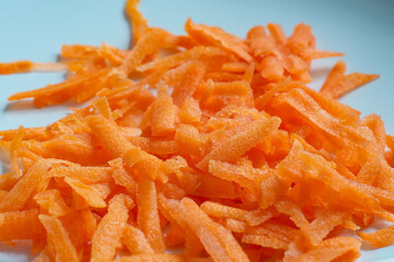 grated carrots on a bluish background