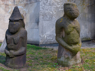 closeup old ancient statues near a wall, museum scene