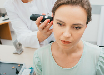 Female patient having ear video otoscopy procedures in an audiologist's office. Close-up. Hearing...