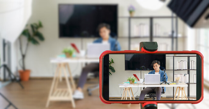 vlogger sitting in studio waiting for time to broardcast live online