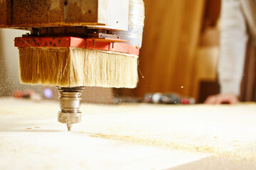 Machine with numerical control cuts wood. CNC device in the carpentry shop.