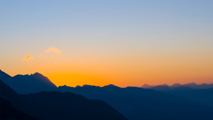 Fototapeta na wymiar mountain chain silhouette at the sunset, twilight mountain landscape
