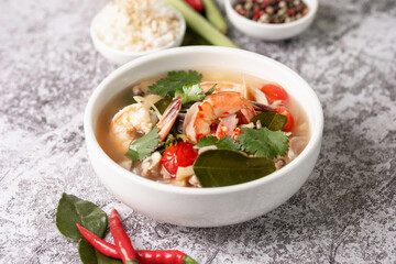 Food and drink, traditional Thai cuisine. Spicy tom yam kung, tom yum sour soup with shrimp, prawn, coconut milk, lemongrass and chili pepper in a bowl