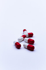 Capsule pills on white background, close-up of a drugs that could give addiction.