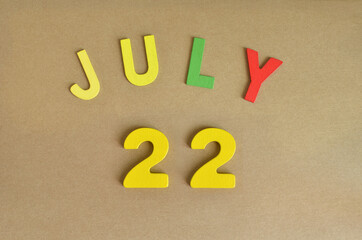 July 22, Toy alphabet with a brown background.