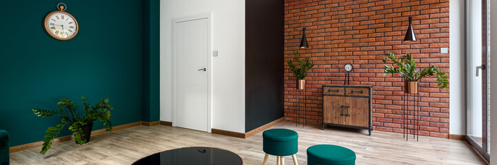 Living room with emerald and brick walls