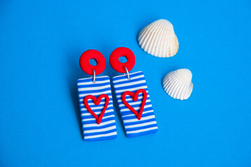 Striped blue and white earrings with red hearts. Handmade jewelry design. Summer jewelry.