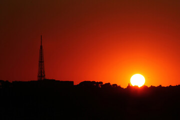 Silhouette of Telecommunication mast television antennas on sunset