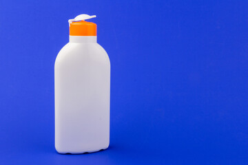 Sunscreen bottle on blue background. Health concepts and skin care
