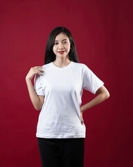 Front view white t-shirt Closeup on female body, woman girl in empty white t-shirt isolated on red background. Design woman t-shirt template and mockup for print.