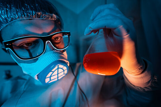 Young male researcher carrying out scientific experiment.