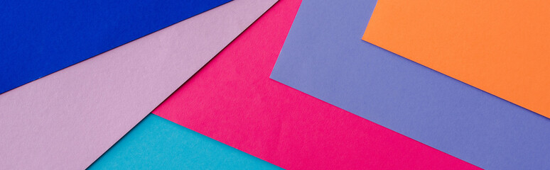 abstract geometric background with orange, pink, blue and violet paper, panoramic shot