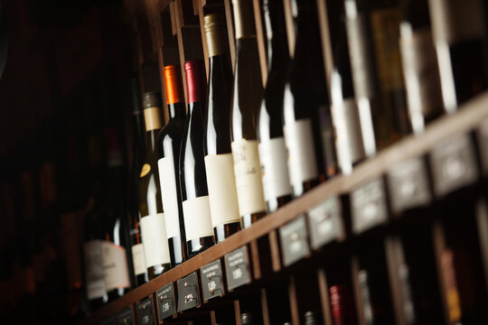 Wine cellar with elite drinks on shelves with written names