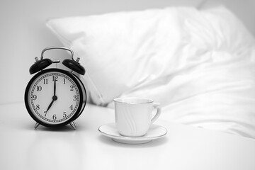 Image of coffee cup and alarm clock.