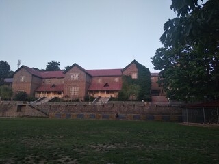 School building  With green trees
