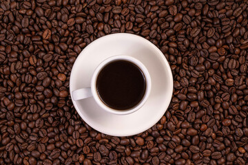 Cup of coffee on coffee beans background