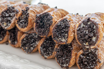 close up of Italian cannoli with ricotta and chocolate sprinkles wedding favors party food