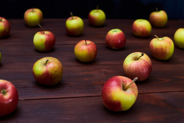 Fresh red-green apples on a wooden background.