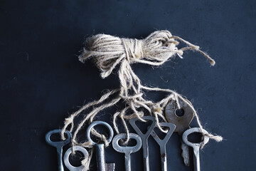 Set of vintage keys for a lock. Retro keys on a dark stone background. The concept of choosing the...