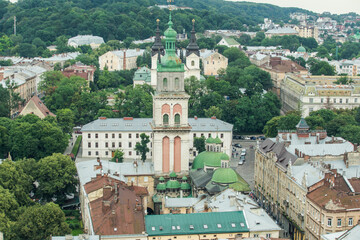 Fototapeta na wymiar top view from city hall tower on old high catholic cathedral tower in Lviv city, Ukraine