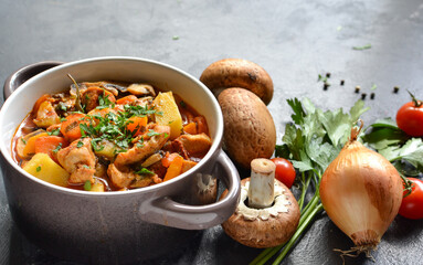 Stew with chicken, potatoes, onions, mushrooms, tomatoes and carrots, and parsley. Vegetable stew....