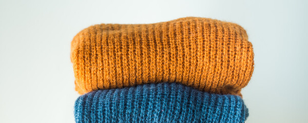 Pile of colorful woolen sweaters. Fall, winter fashion colors