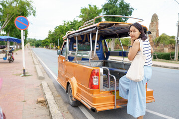 Beautiful Asian tourists Walking, taking photos and traveling on holidays The old town, world heritage city Ayutthaya kingdom Phra Nakhon Si Ayutthaya, Thailand