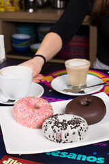 Young girl issues an order of coffee and sweet donuts
